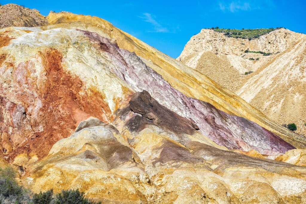 Exposed mineral-rich rock layers in hillside